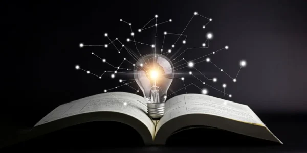 A shining bright bulb standing on an open book