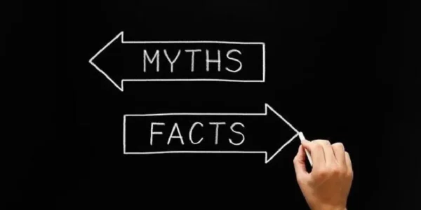 Hand drawing opposite arrows with text on them as "Myths"and "Facts"